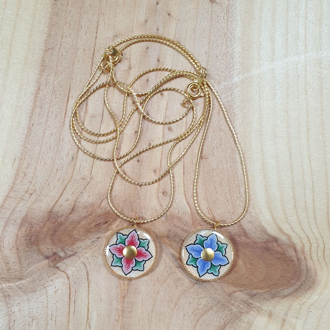 Halsband med rosa eller blå blommor på guldkedja